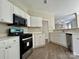 Modern kitchen with white cabinets, and stainless steel oven and microwave at 11339 Fox Hill Dr, Charlotte, NC 28269