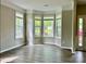 Sunlit living room featuring wood floors, neutral paint, and a bay window overlooking the front yard at 11339 Fox Hill Dr, Charlotte, NC 28269