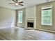 Bright living room with fireplace, ceiling fan and wood-look flooring at 11339 Fox Hill Dr, Charlotte, NC 28269