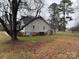 Large backyard with open grass area, mature trees, and minimal landscaping at 1217 West Manor Dr, Lancaster, SC 29720