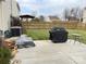 Fenced backyard featuring a concrete patio, well-maintained lawn, grill and an outdoor table and chairs at 14809 Castletown House Dr, Charlotte, NC 28273