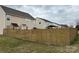 Fenced backyard with a lawn and a view of the back of the house at 14809 Castletown House Dr, Charlotte, NC 28273