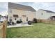 Home's fenced backyard, including a lawn and paver patio with outdoor seating, grill, and backyard entry at 14809 Castletown House Dr, Charlotte, NC 28273