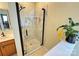 Bathroom shower with a frameless glass door, marble tile, and a built-in shelf for toiletries at 14809 Castletown House Dr, Charlotte, NC 28273