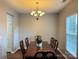 Formal dining room featuring a wooden table, chairs, and chandelier lighting at 14809 Castletown House Dr, Charlotte, NC 28273