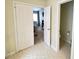 Hallway view into another room and a half bathroom featuring tile floor at 14809 Castletown House Dr, Charlotte, NC 28273