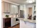 Modern kitchen with granite countertops, stainless steel appliances, and gray cabinetry at 14809 Castletown House Dr, Charlotte, NC 28273