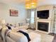 Cozy living room features a fireplace, modern lighting, and comfortable seating at 14809 Castletown House Dr, Charlotte, NC 28273