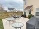Paver patio features outdoor furniture including tables, chairs, and covered grill; wooden privacy fence surrounds at 14809 Castletown House Dr, Charlotte, NC 28273