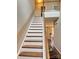 Staircase with wood treads and white risers leads to the upper level of the home at 14809 Castletown House Dr, Charlotte, NC 28273