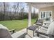 Covered patio with outdoor seating, overlooking a spacious backyard with lush greenery and trees at 1809 Ab Moore Jr Dr # 3238, Indian Trail, NC 28079