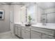 Well-lit bathroom with dual vanities, modern fixtures, a large mirror, and a view of the shower at 1809 Ab Moore Jr Dr # 3238, Indian Trail, NC 28079
