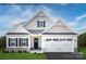 Inviting two-story home featuring a two-car garage, neutral siding, stone accents, and a well-manicured lawn at 1809 Ab Moore Jr Dr # 3238, Indian Trail, NC 28079