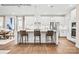 Bright kitchen features white cabinets, stainless appliances, island with seating, and hardwood floors at 1809 Ab Moore Jr Dr # 3238, Indian Trail, NC 28079