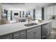 Open-concept kitchen showcases a large island, stainless steel appliances, and a view of the living and dining areas at 1809 Ab Moore Jr Dr # 3238, Indian Trail, NC 28079