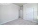 Cozy bedroom showcasing neutral carpet, white trim, and a spacious closet at 2016 Skyhawk Dr, Lake Wylie, SC 29745