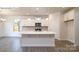 Modern kitchen featuring an island, stainless steel appliances, and an adjacent dining area at 2016 Skyhawk Dr, Lake Wylie, SC 29745