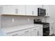 Modern kitchen featuring white cabinetry, stainless steel appliances, and herringbone backsplash at 2016 Skyhawk Dr, Lake Wylie, SC 29745