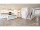 Open-concept living space with a modern kitchen, dining area, and a staircase at 2016 Skyhawk Dr, Lake Wylie, SC 29745