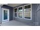 Covered patio with door, three windows, and concrete flooring, providing an outdoor space at 2016 Skyhawk Dr, Lake Wylie, SC 29745