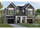 New construction with a two-car garage and green siding, with an inviting walkway to the front doors at 2021 Mandarin Blvd, Charlotte, NC 28205