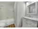 Bathroom featuring white vanity with marble countertop and tile surround bathtub at 2500 Cranbrook Ln # 5, Charlotte, NC 28207
