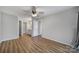 This bedroom includes an ensuite bathroom, a walk-in closet, and wood flooring at 2500 Cranbrook Ln # 5, Charlotte, NC 28207