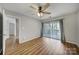 Large bedroom has wood flooring and sliding glass doors to a private balcony at 2500 Cranbrook Ln # 5, Charlotte, NC 28207
