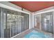 Cozy covered patio featuring sliding glass doors and a decorative blue rug on the rustic wooden floor at 2500 Cranbrook Ln # 5, Charlotte, NC 28207