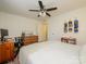 Bright bedroom featuring a comfortable bed, a ceiling fan, and a work space at 2900 Heathstead Pl # A, Charlotte, NC 28210