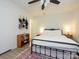 Well-lit bedroom with white walls, a black metal bed frame, and a ceiling fan at 2900 Heathstead Pl # A, Charlotte, NC 28210