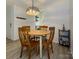 Charming dining area features a round wood table with seating for four, adjacent to the kitchen at 2900 Heathstead Pl # A, Charlotte, NC 28210