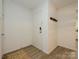 Bright condo entryway with wood floors, a white door, and coat hooks for convenience at 2900 Heathstead Pl # A, Charlotte, NC 28210
