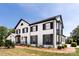 Elegant home with white brick, black shutters, and a manicured lawn showcasing sophisticated charm at 2900 Heathstead Pl # A, Charlotte, NC 28210