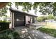 Detached garage featuring a covered porch with seating, offering parking and curb appeal at 2900 Heathstead Pl # A, Charlotte, NC 28210