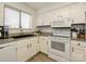 Bright kitchen with white cabinets, granite countertops, and appliances, ideal for any home chef at 2900 Heathstead Pl # A, Charlotte, NC 28210