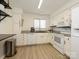 Bright kitchen with white cabinets, granite countertops, and stainless steel appliances, ready for cooking at 2900 Heathstead Pl # A, Charlotte, NC 28210