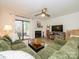 Inviting living room with a fireplace, sliding glass doors and plush green sectional sofa at 2900 Heathstead Pl # A, Charlotte, NC 28210