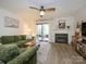 Inviting living room with a fireplace, plush green sofa, and access to outdoor space, perfect for relaxation at 2900 Heathstead Pl # A, Charlotte, NC 28210