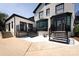 Back of house features a walkout basement, black trim and door, a staircase and a cement patio at 2900 Heathstead Pl # A, Charlotte, NC 28210