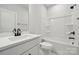 Clean, white bathroom featuring a vanity with a bright sink and a tub-shower combo with black hardware at 304 Balboa St, Matthews, NC 28104