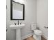 Well-lit half bathroom featuring a stylish pedestal sink and modern fixtures, creating a functional space at 304 Balboa St, Matthews, NC 28104