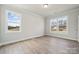 Bright, airy bedroom with natural light flooding through two large windows, illuminating the hardwood floors at 304 Balboa St, Matthews, NC 28104