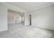 Spacious bedroom features neutral walls, plush carpet, and open access to a hallway and additional room at 304 Balboa St, Matthews, NC 28104