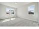 Bright bedroom with plush carpeting and large windows offering natural light at 304 Balboa St, Matthews, NC 28104