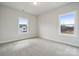 Sunlit bedroom with soft carpet, neutral walls, and ample natural light through two bright windows at 304 Balboa St, Matthews, NC 28104