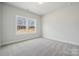 Bright bedroom with large double windows offering natural light and neutral color walls and flooring at 304 Balboa St, Matthews, NC 28104