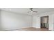 Spacious bedroom showcasing hardwood floors, a ceiling fan, and an open doorway at 304 Balboa St, Matthews, NC 28104