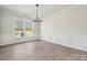 Formal dining room with decorative molding, contemporary chandelier, and hardwood flooring at 304 Balboa St, Matthews, NC 28104