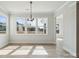 Bright dining room with large windows, wood floors, and modern light fixture, offering community views at 304 Balboa St, Matthews, NC 28104